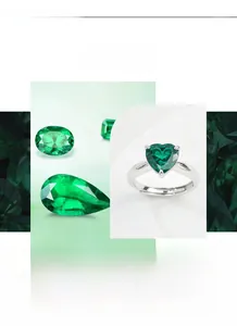 Detail of heart-shaped emerald green gemstone with white cubic zirconia in claw setting