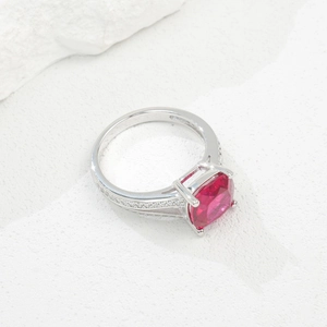 Elegant silver ring with a large square cushion-cut ruby gemstone and side diamonds