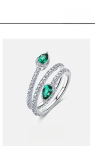 Detail of S925 silver ring featuring pear-cut emeralds and micro-pave white zircons