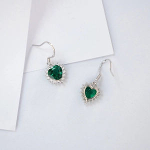 Detail of heart-cut green emerald drop earrings with sparkling zircon halo in S925 silver