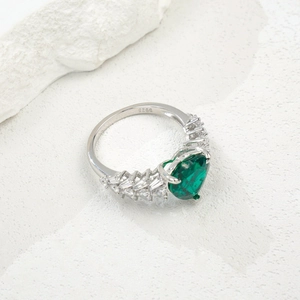S925 sterling silver ring with pear-cut emerald gemstone on a natural stone base