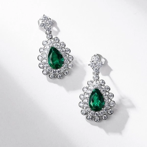Luxurious S925 silver stud earrings featuring pear-cut emerald and sparkling zircon halo