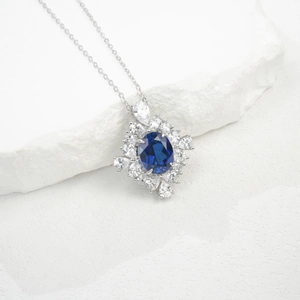 Detailed close-up of a luxury oval blue sapphire pendant necklace with S925 silver chain