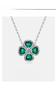 Macro detail of clover pendant featuring lab-grown emeralds and a sparkling carbon diamond