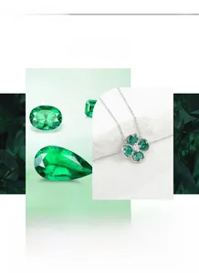 Macro detail of emerald clover necklace with pear-cut green stones and silver chain