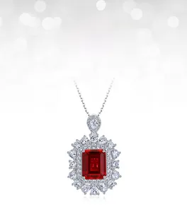 Close-up of radiant rectangle-cut ruby pendant with double-layer diamond halo setting