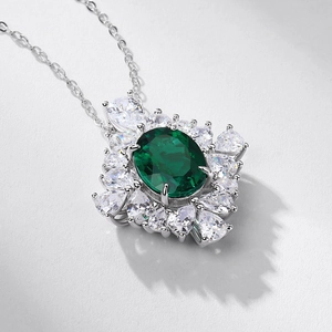 Luxurious S925 silver necklace featuring an oval emerald green gem with white zircon halo