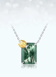 Macro view of rectangular moss agate necklace pendant with a golden ladybug detail