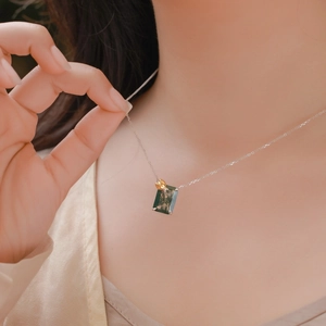 Close-up of moss agate necklace with golden lotus bud pendant on S925 silver chain
