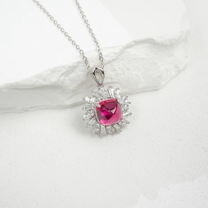 Macro detail of S925 silver necklace with square rose-red gem and zircon cluster