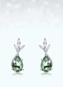 Detailed macro view of pear-shaped green moss agate earrings with sparkling zircon accents