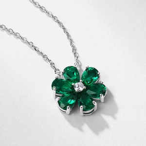 Floral S925 silver necklace with pear-cut emerald gemstones and a central clear diamond