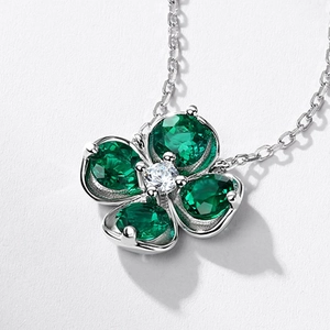 Elegant silver clover necklace with emerald green heart petals and center crystal