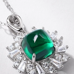 Luxurious S925 emerald green necklace with sparkling zircon halo on white background