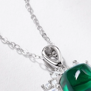 S925 sterling silver necklace featuring a sugarloaf emerald pendant with pavé halo