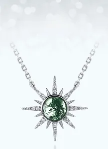 Close-up of starburst necklace with moss agate stone and shimmering zircon inlay