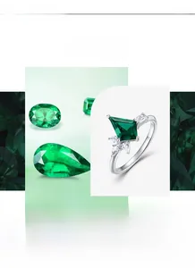 Macro view of kite-shaped emerald ring with silver band and geometric zircon accents