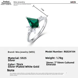 Detail of S925 silver ring with kite-cut emerald and sparkling white zircon stones