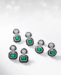 Detailed close-up of emerald-cut and square lab-grown emerald studs with white zircons