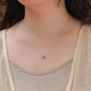 Elegant S925 silver sun pendant necklace featuring natural green moss agate on model