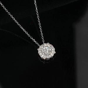 Macro shot of silver S925 geometric pendant with sparkling lab diamond on black background