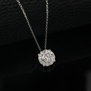 Close-up of S925 silver necklace featuring a cluster-set round moissanite pendant