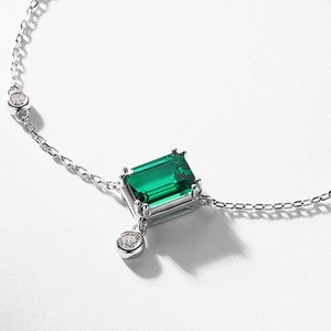 Elegant S925 silver bracelet with emerald-cut green gemstone and cubic zirconia accents