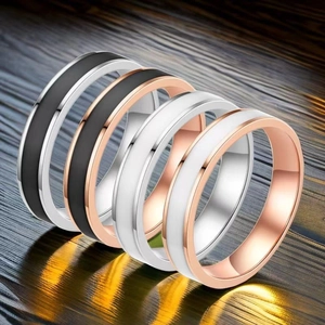 Detail view of colorful enamel and stainless steel rings in silver and rose gold finish