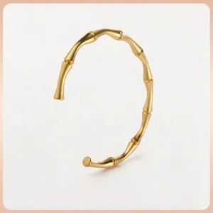 Minimalist gold bamboo joint open bangle in titanium steel with matte textured finish