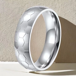 Macro view of silver stainless steel ring with hexagonal honeycomb pattern and polished edges