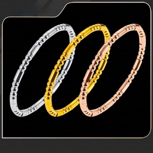 Macro shot of titanium steel bangles in silver, gold and rose gold with bamboo texture