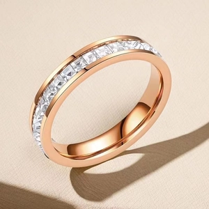 Macro detail of rose gold eternity ring featuring square-cut sparkling cubic zirconia