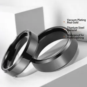 Polished black titanium steel rings for men with a matte finish on geometric pedestal