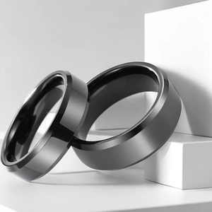 Detail of brushed black stainless steel rings with polished beveled edges in macro view