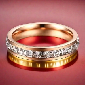 Macro shot of rose gold titanium steel ring with channel-set square cut zircons