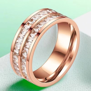 Macro detail of rose gold titanium ring featuring double row square zircon inlay