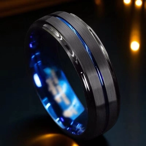 Macro shot of men's brushed black titanium ring with blue inner band and grooved center