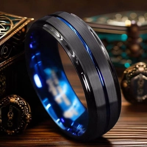 Macro shot of black brushed titanium ring with blue groove and polished blue inner band
