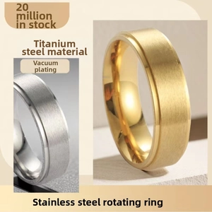 Macro detail of rotating titanium steel spinner rings in gold and silver finish