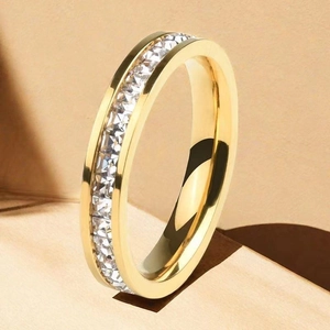 Macro detail of 18K gold plated eternity ring with square-cut white zircons stones