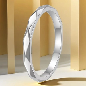 Macro shot of silver geometric faceted ring with modern minimalist industrial design