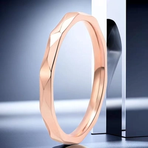 Macro shot of rose gold faceted ring showing irregular geometric light reflections