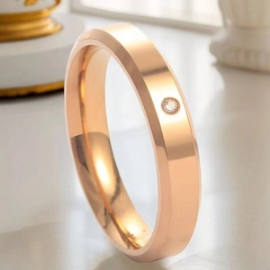 Macro close-up of rose gold stainless steel ring with a sparkling inset zircon stone