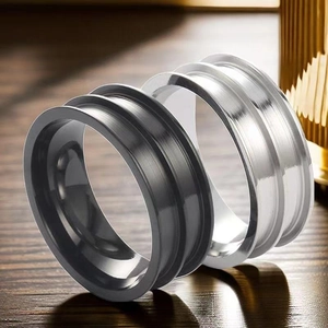 Close-up of DIY stainless steel ring bases with grooves in black and silver metal finish