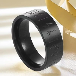 Macro view of black stainless steel ring with Nordic Runes engraving for men