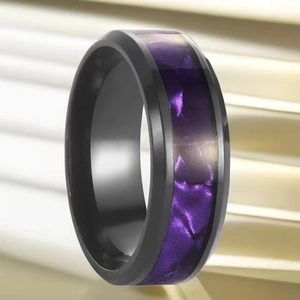 Macro shot of matte black stainless steel ring featuring a purple wave textured inlay