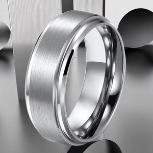 Macro shot of silver brushed steel ring with polished beveled edges and industrial style