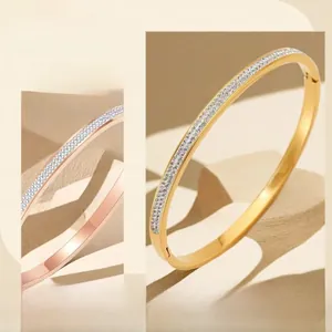 Detail of 18k gold plated titanium steel bangle featuring a single row of inlaid zircons