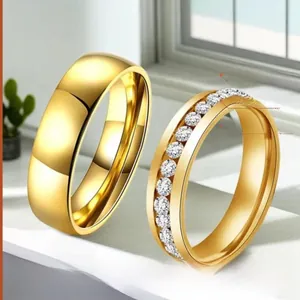 Close-up of gold plated stainless steel couple rings with cubic zirconia inlay detail