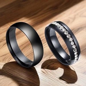 Close-up of black titanium steel couple rings set with micro-paved sparkling crystals